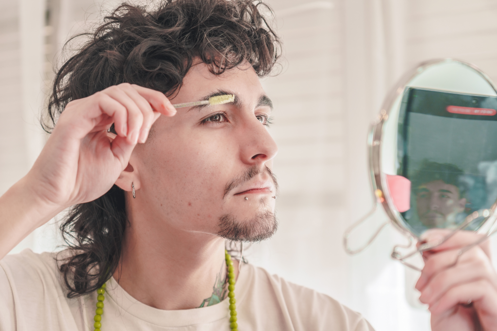 young man trying to regrow eyebrows using natural methods