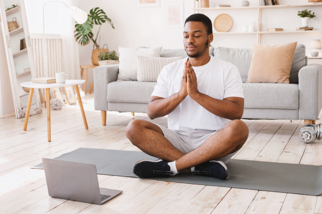 man doing yoga using best free self care apps