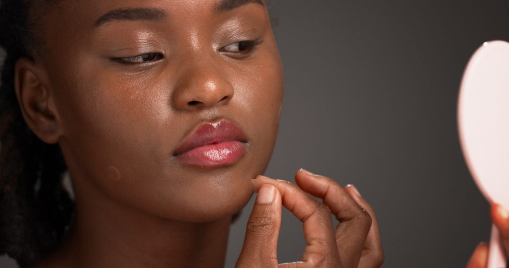 young woman applying patches to get rid of a pimple overnight