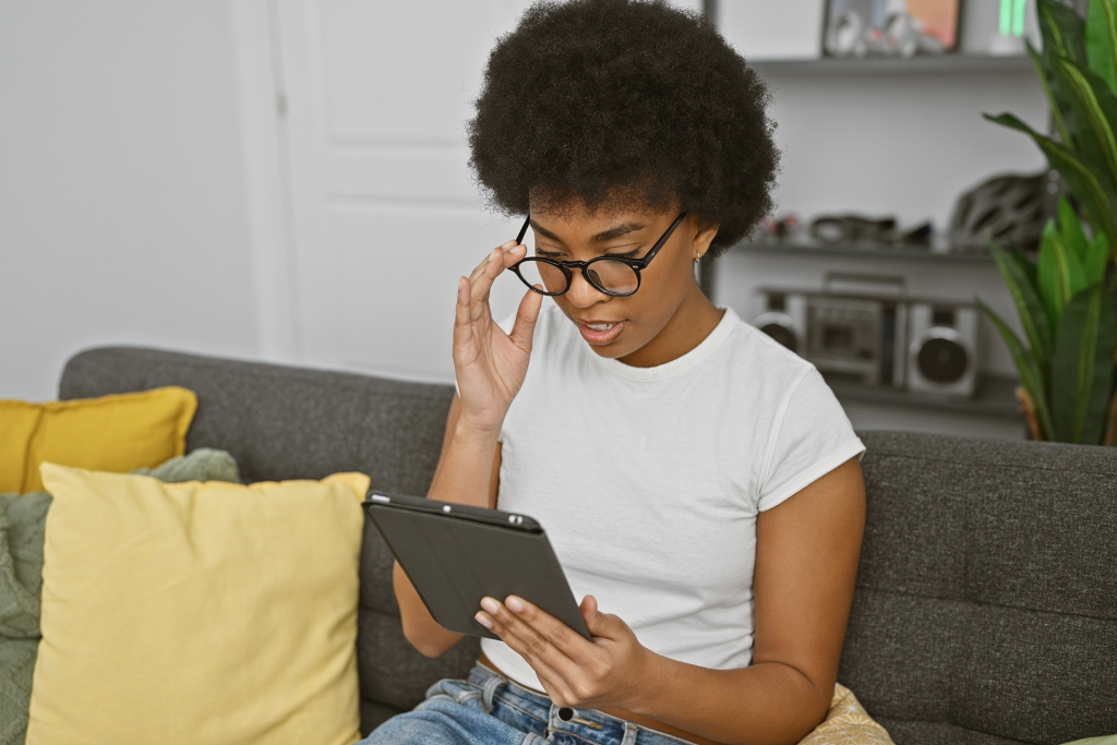 young woman holding a tablet looking into apps for healthy lifestyle
